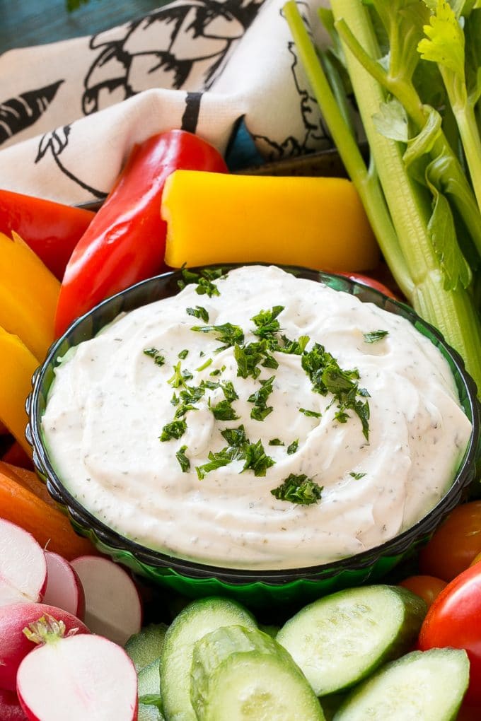 Homemade Ranch Dip Recipe | Homemade Ranch Powder | Homemade Ranch Dressing | Best Ranch Dip #ranch #dip #appetizer #snack #bajap A bowl of dip topped with chopped parsley and surrounded by vegetables.