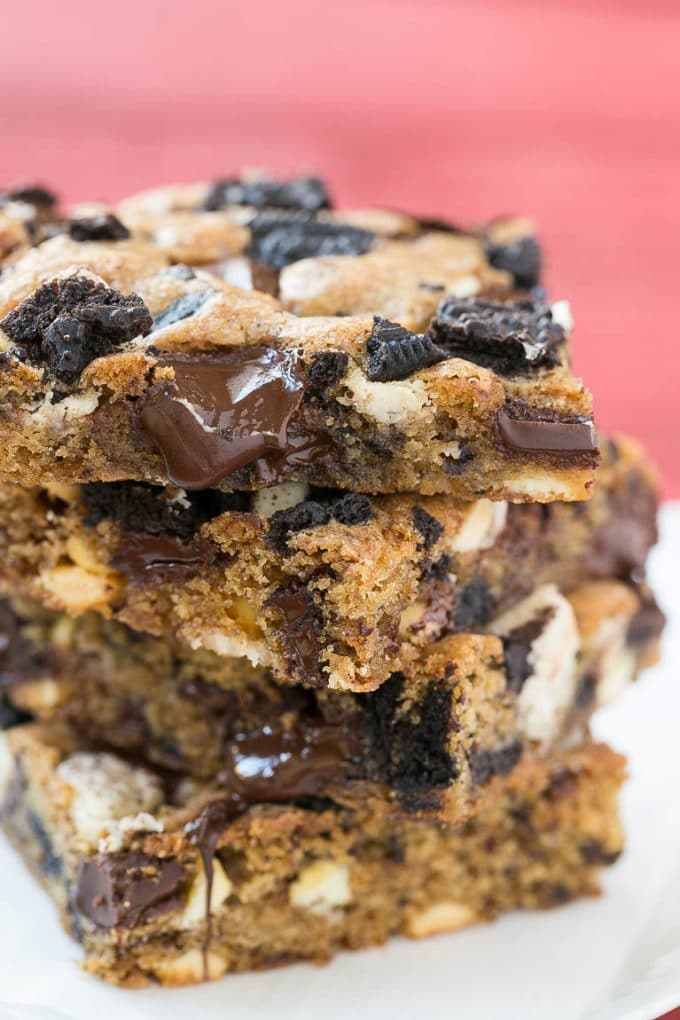 Cookies and Cream Bars Recipe | Oreo Bars | Blondie Recipe #chocolate #oreo #blondies #baking #cookies #bajap A stack of blondies filled with chocolate chunks and chopped cookies.