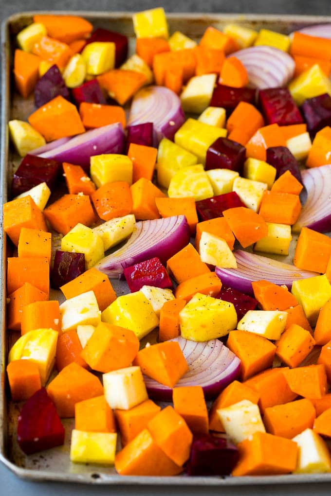 Roasted Root Vegetables Recipe | Roasted Sweet Potatoes | Roasted Beets | Roasted Carrots #carrots #beets #vegetables #sweetpotatoes #fall #parsnips #sidedish #bajap #cleaneating #healthy A mixture of root vegetables tossed with olive oil and garlic.