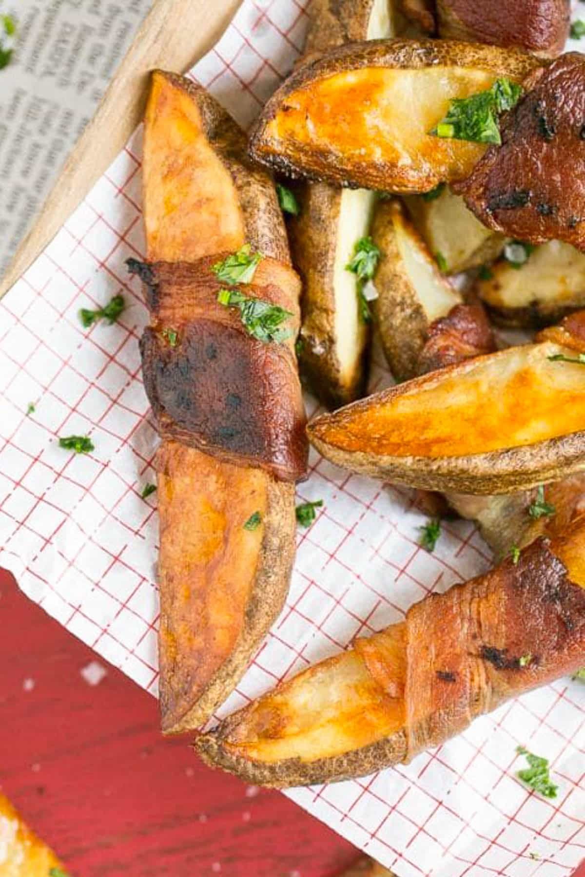 Bacon Wrapped Potato Wedges Recipe | Best Potato Wedges | Bacon Wrapped French Fries | Bacon Potato Wedges #bacon #potato #fries #dinner #bajap Bacon wrapped potatoes on a serving tray, topped with parsley.