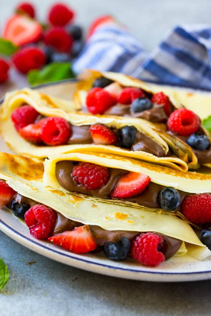 Nutella Crepes Recipe | Easy Crepes Recipe | Blender Crepes | Berry Crepes #crepes #nutella #nutellacrepes #blendercrepes #breakfast #bajap A stack of crepes that are stuffed full of chocolate Nutella spread and fresh berries.