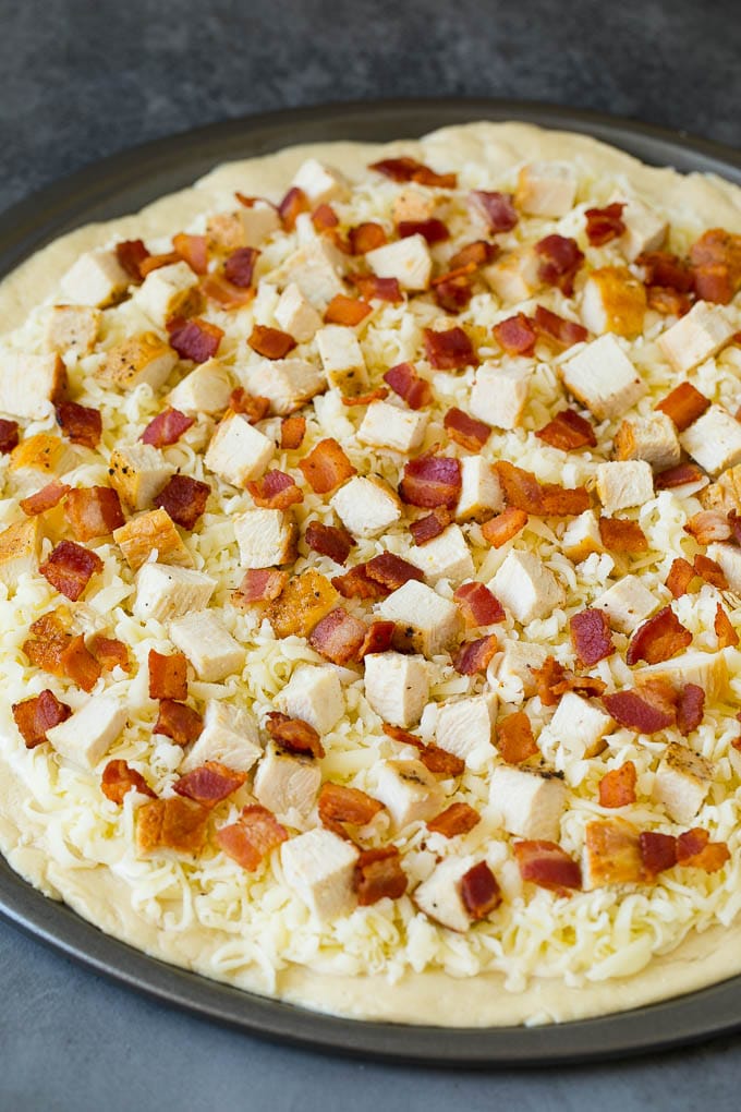 Chicken Alfredo Pizza Recipe #pizza #chicken #bacon #dinner #bajap A crust topped with sauce, shredded cheese and meat.