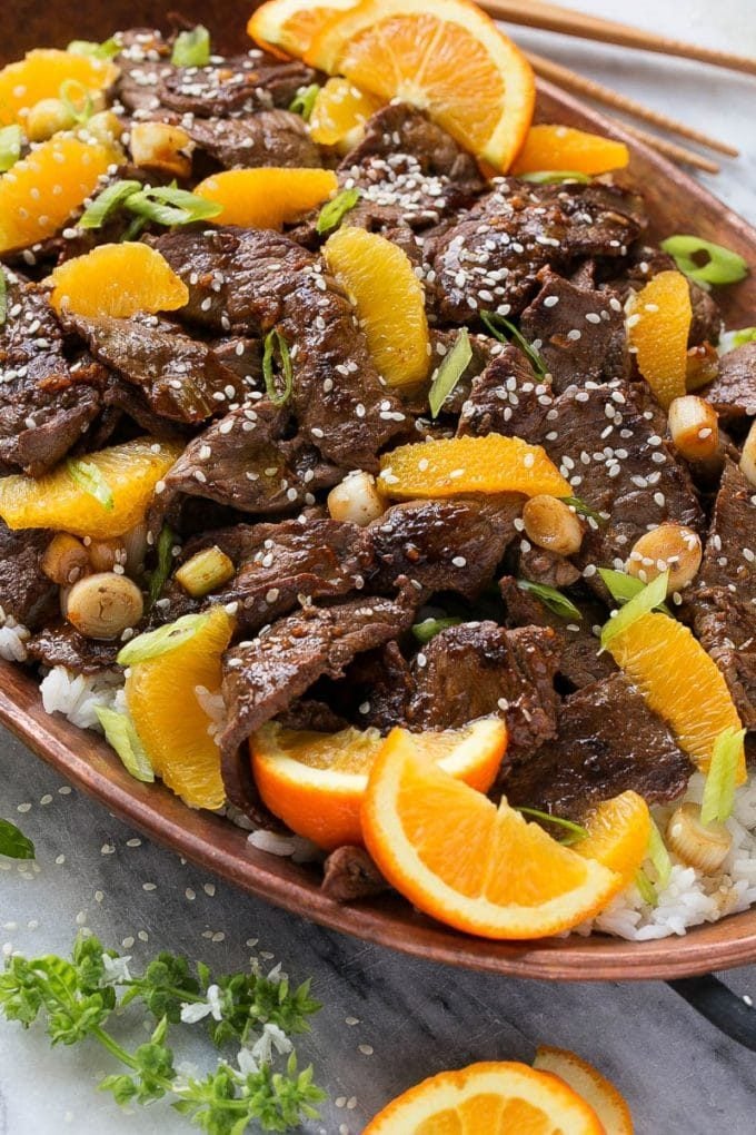 Orange Beef Stir Fry Recipe | 4 Ingredient Orange Beef | Easy Orange Beef #orange #beef #stirfry #asian #dinner #bajap Orange beef topped with green onions and sesame seeds.