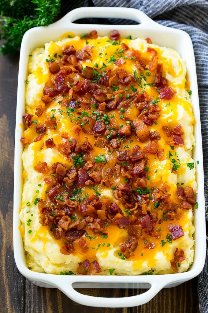 Loaded Mashed Potato Casserole Recipe | Loaded Potatoes | Bacon Mashed Potatoes | Thanksgiving Mashed Potatoes #potatoes #bacon #cheese #casserole #Thanksgiving #dinner #bajap Loaded mashed potato casserole topped with melted cheese, bacon and herbs.