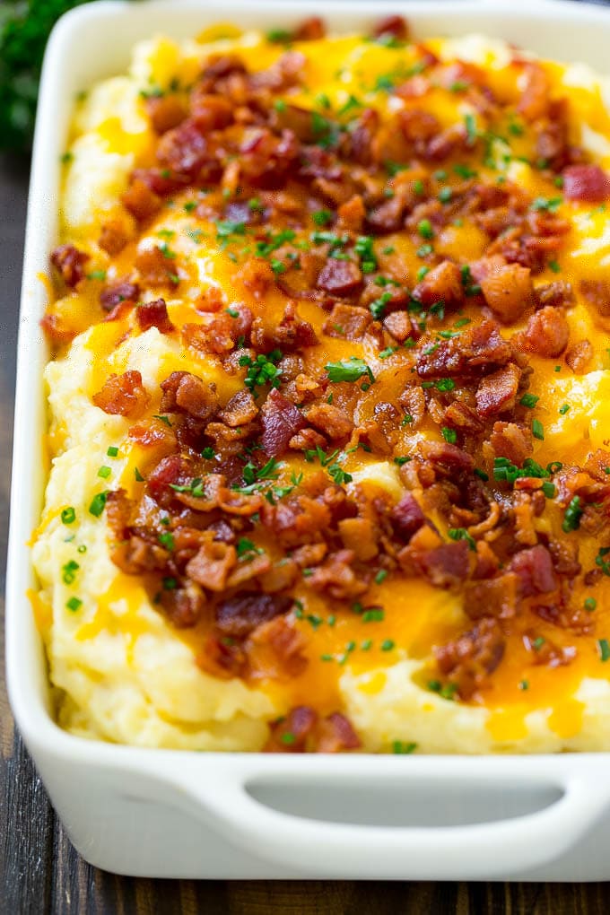 Loaded Mashed Potato Casserole Recipe | Loaded Potatoes | Bacon Mashed Potatoes | Thanksgiving Mashed Potatoes #potatoes #bacon #cheese #casserole #Thanksgiving #dinner #bajap A casserole of loaded mashed potatoes topped with cheddar cheese, crispy bacon and chives.