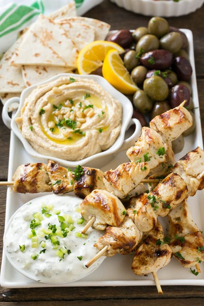 Greek Chicken Souvlaki Recipe | Easy Greek Chicken | Chicken Souvlaki | Greek Chicken Skewers | Easy Greek Chicken Skewers #chicken #kabobs #glutenfree #keto #lowcarb #grilling #bajap Chicken souvlaki skewers marinated in lemon and herbs, then grilled. Served with olives, hummus and pita bread.