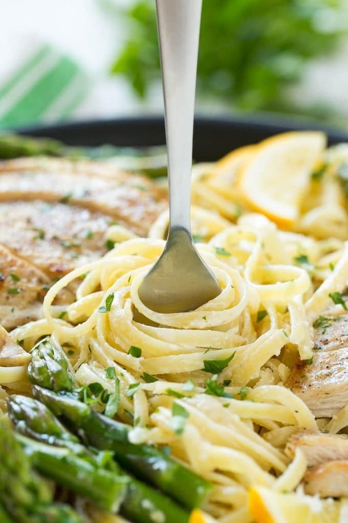 Lemon Asparagus Pasta with Grilled Chicken Recipe | Asparagus Pasta | Grilled Chicken Pasta | Easy Pasta Recipe #pasta #asparagus #lemon #chicken #dinner #bajap A fork serving up a portion of creamy pasta.