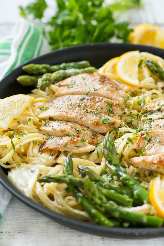 Lemon Asparagus Pasta with Grilled Chicken Recipe | Asparagus Pasta | Grilled Chicken Pasta | Easy Pasta Recipe #pasta #asparagus #lemon #chicken #dinner #bajap A skillet with lemon asparagus pasta, cream sauce and sliced grilled chicken.