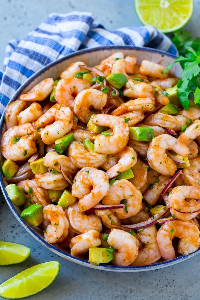 Mexican Shrimp Cocktail Recipe | Coctel de Camarones | Shrimp Cocktail | Mexican Shrimp #shrimp #appetizer #avocado #mexican #bajap A bowl of Mexican shrimp cocktail with red onion, avocado, homemade sauce and cilantro.