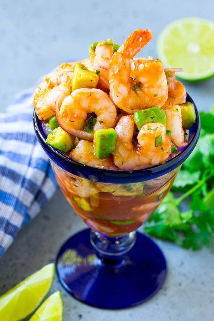 Mexican Shrimp Cocktail Recipe | Coctel de Camarones | Shrimp Cocktail | Mexican Shrimp #shrimp #appetizer #avocado #mexican #bajap An individual cup of Mexican shrimp cocktail with red onion and avocado.