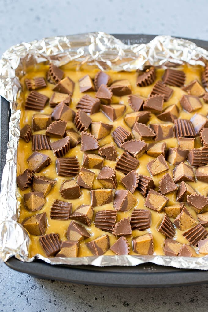 Chocolate Peanut Butter Fudge Recipe | Peanut Butter Cup Fudge | Easy Fudge Recipe #chocolate #peanutbutter #fudge #baking #dessert #bajap Layered peanut butter chocolate fudge in a square pan.