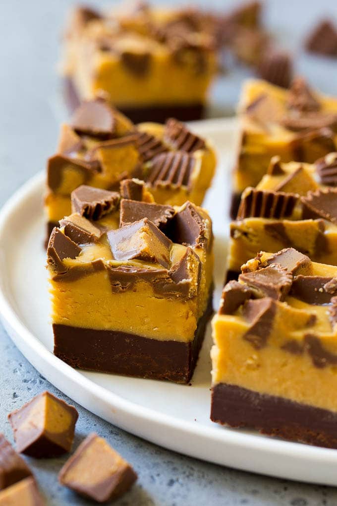 Chocolate Peanut Butter Fudge Recipe | Peanut Butter Cup Fudge | Easy Fudge Recipe #chocolate #peanutbutter #fudge #baking #dessert #bajap Squares of chocolate peanut butter fudge topped with peanut butter cups.