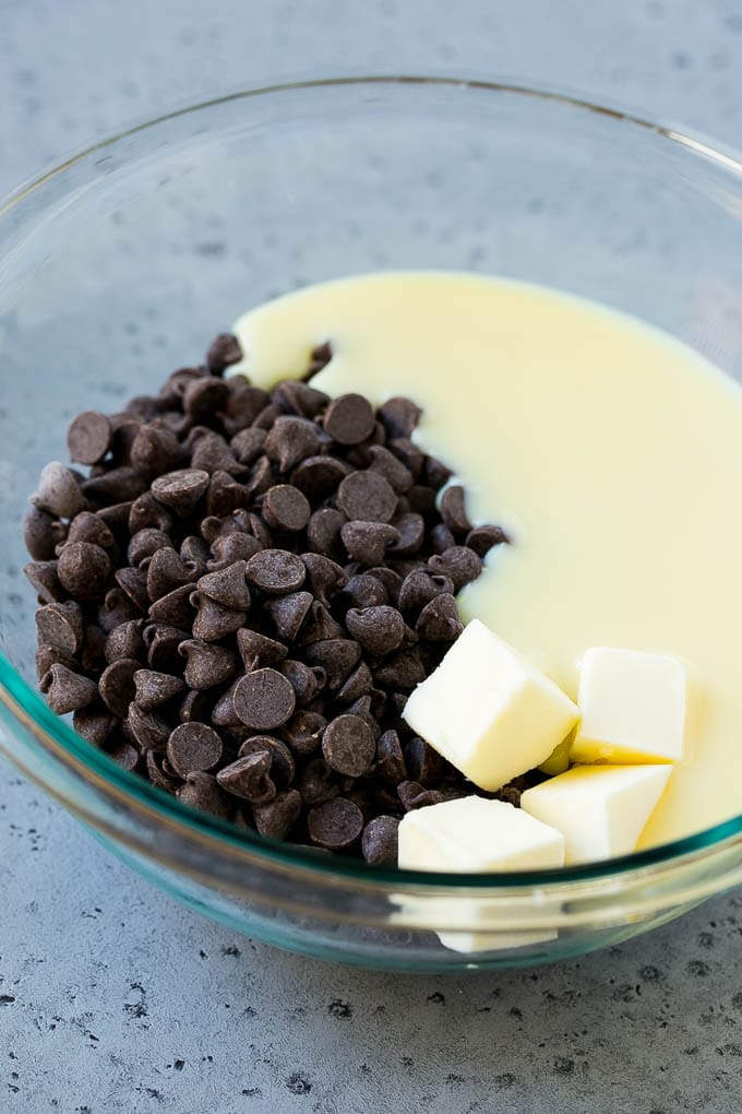 Chocolate Peanut Butter Fudge Recipe | Peanut Butter Cup Fudge | Easy Fudge Recipe #chocolate #peanutbutter #fudge #baking #dessert #bajap Chocolate chips, condensed milk and butter in a mixing bowl.