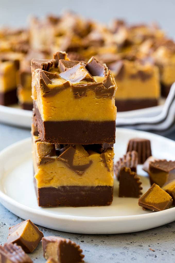 Chocolate Peanut Butter Fudge Recipe | Peanut Butter Cup Fudge | Easy Fudge Recipe #chocolate #peanutbutter #fudge #baking #dessert #bajap Stacked pieces of chocolate peanut butter fudge on a plate.