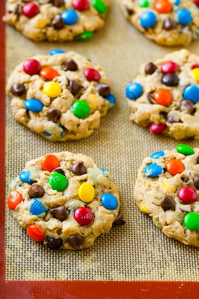 Monster Cookies Recipe | Oatmeal Cookies | Peanut Butter Cookies | M&M's Cookies #baking #cookies #dessert #peanutbutter #chocolate #bajap Baked monster cookies on a sheet pan.