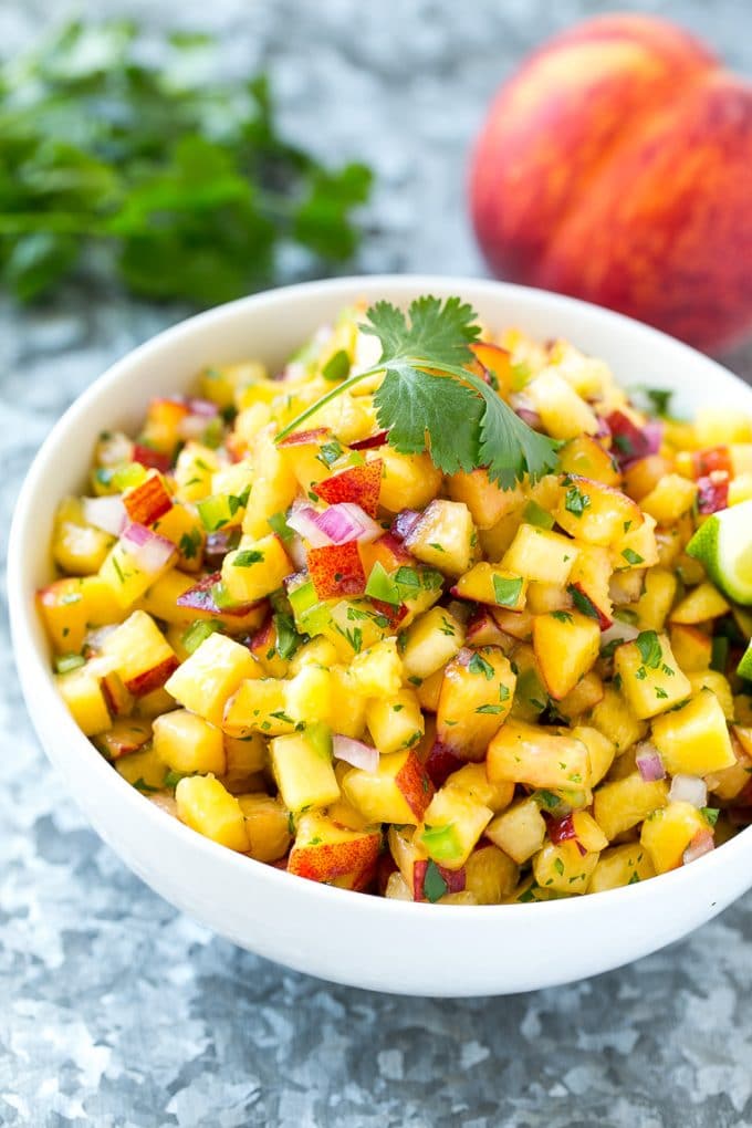 Peach Salsa | Fruit Salsa #peaches #salsa #dip #appetizer #bajap Peach salsa in a bowl made with red onion, jalapeno and cilantro.