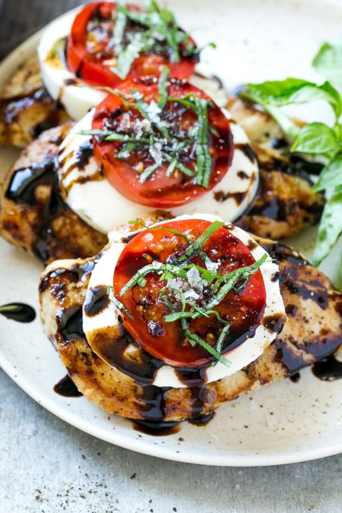 Chicken Caprese Recipe | Grilled Chicken #chicken #caprese #grilling #dinner #tomato #basil #bajap Chicken caprese with sliced tomatoes, balsamic glaze, fresh mozzarella and shredded basil.