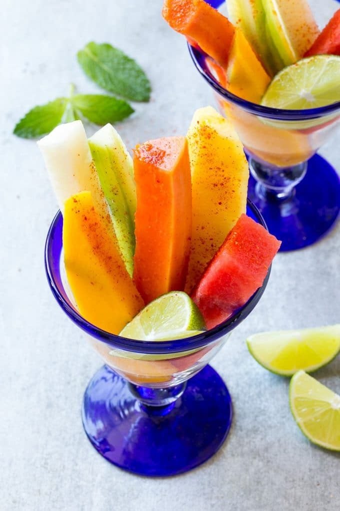 Mexican Fruit Cups | Fruit Cups | Mexican Fruit | Tropical Fruit #fruit #fruitcup #watermelon #pineapple #snack #healthy #bajap Spears of colorful fresh fruit, cucumbers and jicama in Mexican fruit cups.