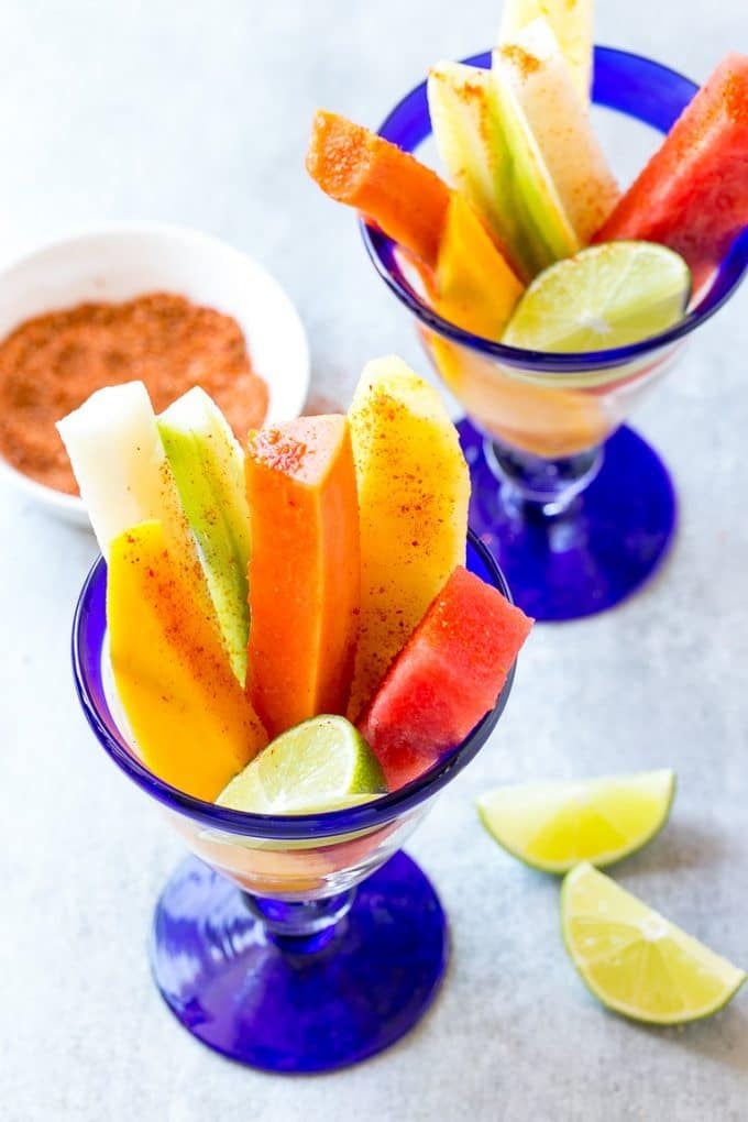 Mexican Fruit Cups | Fruit Cups | Mexican Fruit | Tropical Fruit #fruit #fruitcup #watermelon #pineapple #snack #healthy #bajap Spears of watermelon, cucumber, jicama, mango and pineapple in glasses.