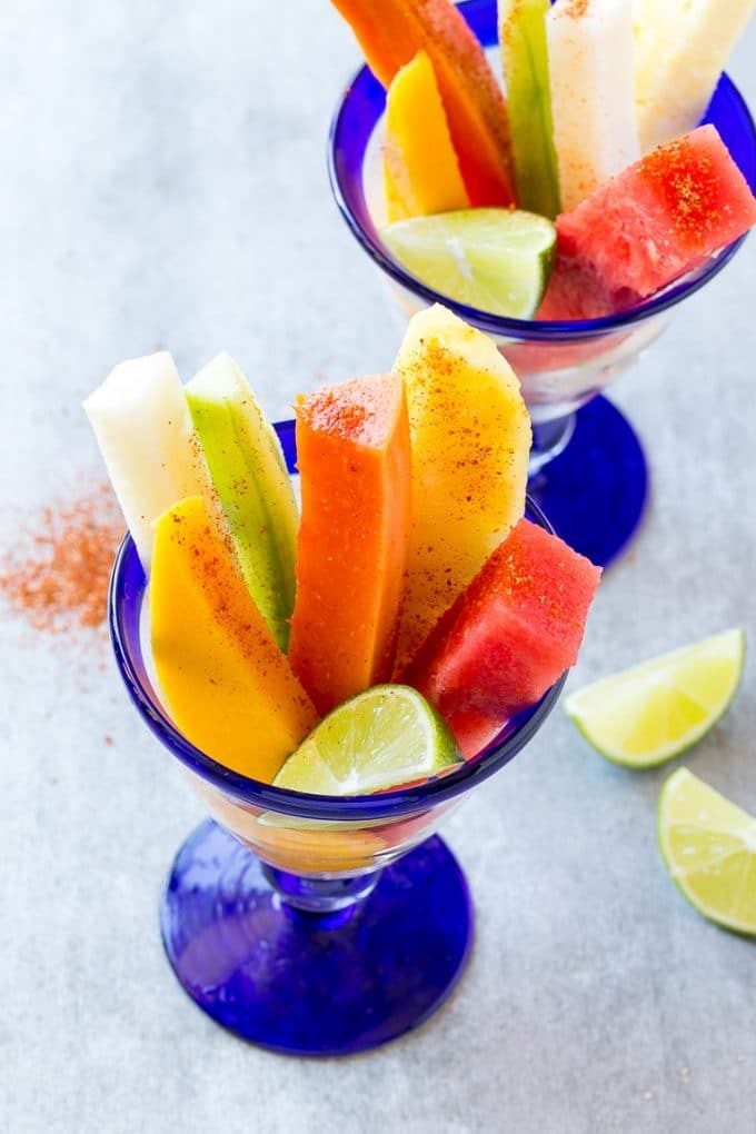 Mexican Fruit Cups | Fruit Cups | Mexican Fruit | Tropical Fruit #fruit #fruitcup #watermelon #pineapple #snack #healthy #bajap Mexican fruit cups with an assortment of fruit, topped with chili lime seasoning.