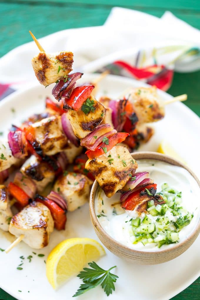 Greek Chicken Kabobs | Grilled Chicken Kabobs | Healthy Chicken Recipe | Greek Chicken #greekfood #chicken #grilling #grilledchicken #kabobs #dinner #bajap Skewered meat and veggies being dipped onto cucumber yogurt sauce.