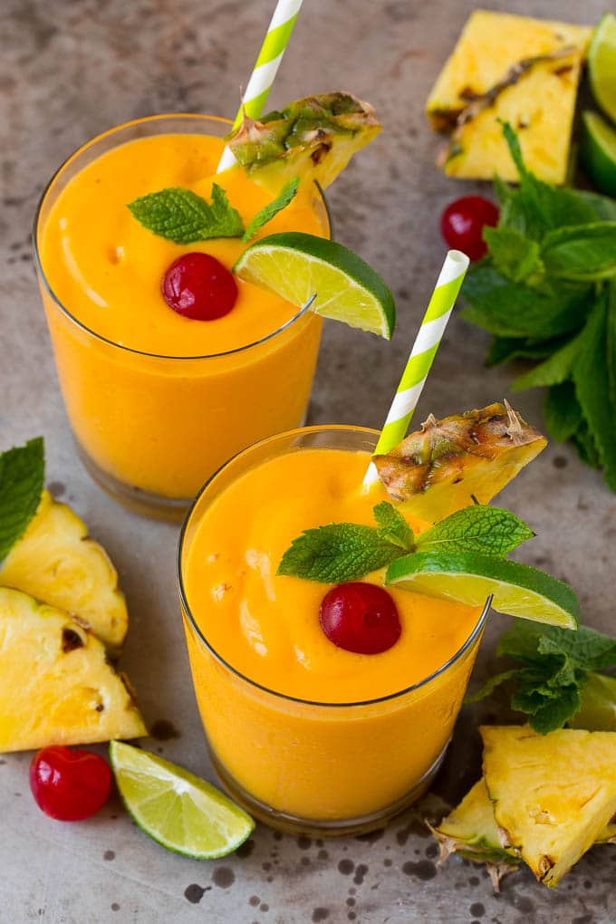 Tropical Smoothie Recipe | Mango Smoothie | Pineapple Smoothie #smoothie #mango #pineapple #banana #drink #bajap Tropical smoothie garnished with mint, limes and pineapple.