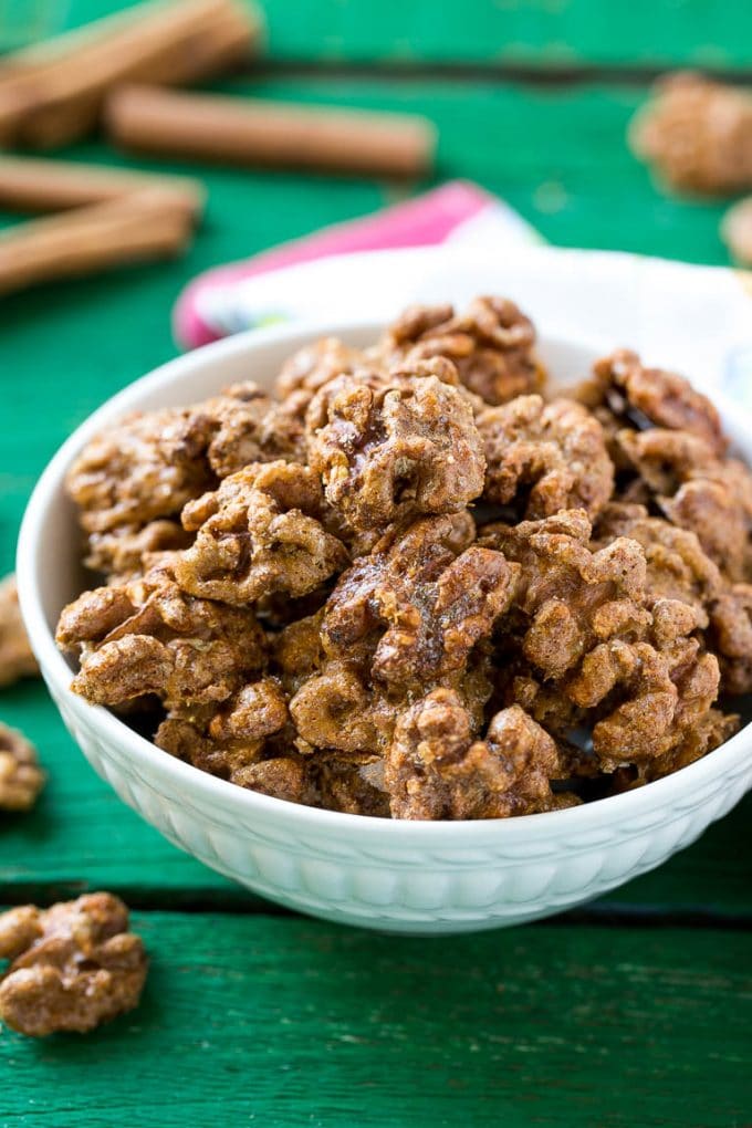 Candied Walnuts Recipe | Candied Nuts | Glazed Walnuts | Cinnamon Sugar Walnuts #walnuts #dessert #snack #bajap A white bowl filled with candied walnuts.