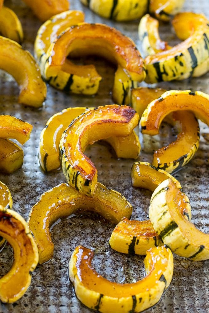 Brown Sugar Delicata Squash Recipe | Roasted Squash | Delicata Squash | Winter Squash Recipe #squash #wintersquash #brownsugar #sidedish #delicatasquash #dinner #bajap Roasted delicata squash on a sheet pan seasoned with brown sugar.