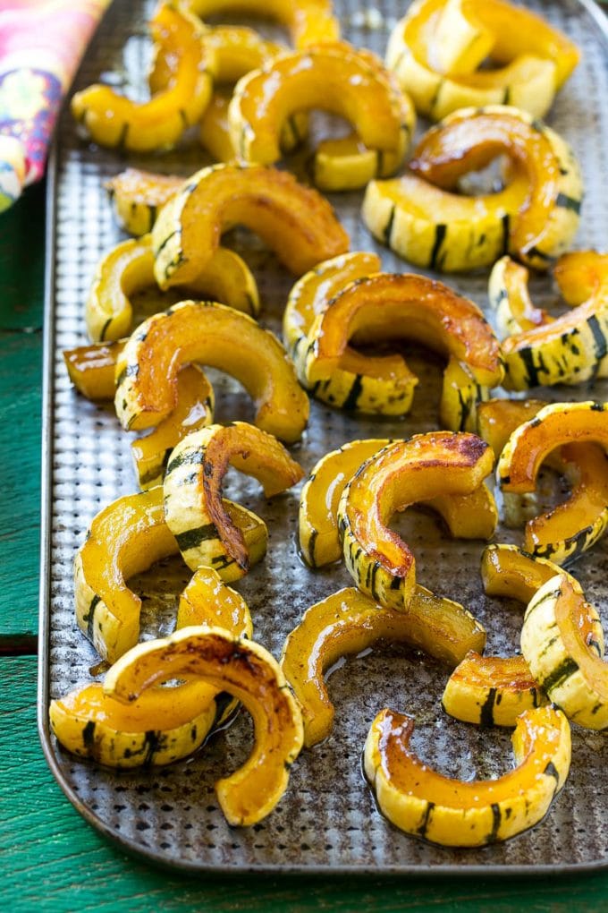 Brown Sugar Delicata Squash Recipe | Roasted Squash | Delicata Squash | Winter Squash Recipe #squash #wintersquash #brownsugar #sidedish #delicatasquash #dinner #bajap A sheet pan of a cooked winter squash recipe.
