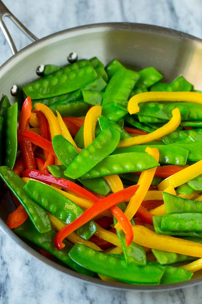 Teriyaki Shrimp Stir Fry Recipe | Shrimp Stir Fry | Healthy Stir Fry #shrimp #teriyaki #vegetables #stirfry #dinner #bajap Cooked snow peas and bell peppers in a skillet.