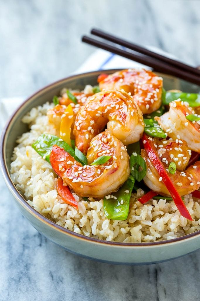 Teriyaki Shrimp Stir Fry Recipe | Shrimp Stir Fry | Healthy Stir Fry #shrimp #teriyaki #vegetables #stirfry #dinner #bajap A bowl of shrimp stir fry and vegetables garnished with sesame seeds.