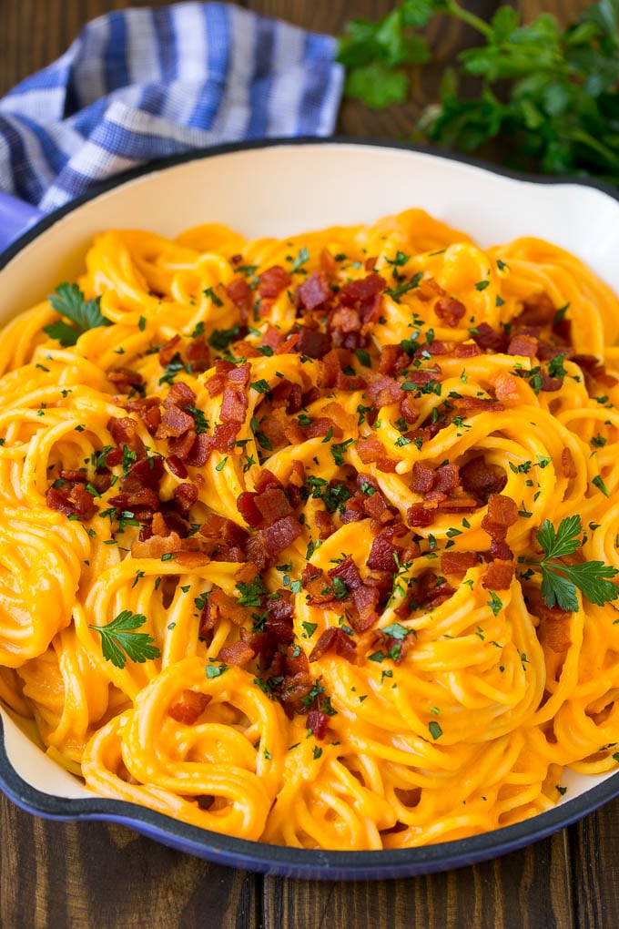 Butternut Squash Pasta Recipe #pasta #squash #bacon #fall #dinner #bajap Butternut squash pasta in a skillet topped with bacon and parsley.