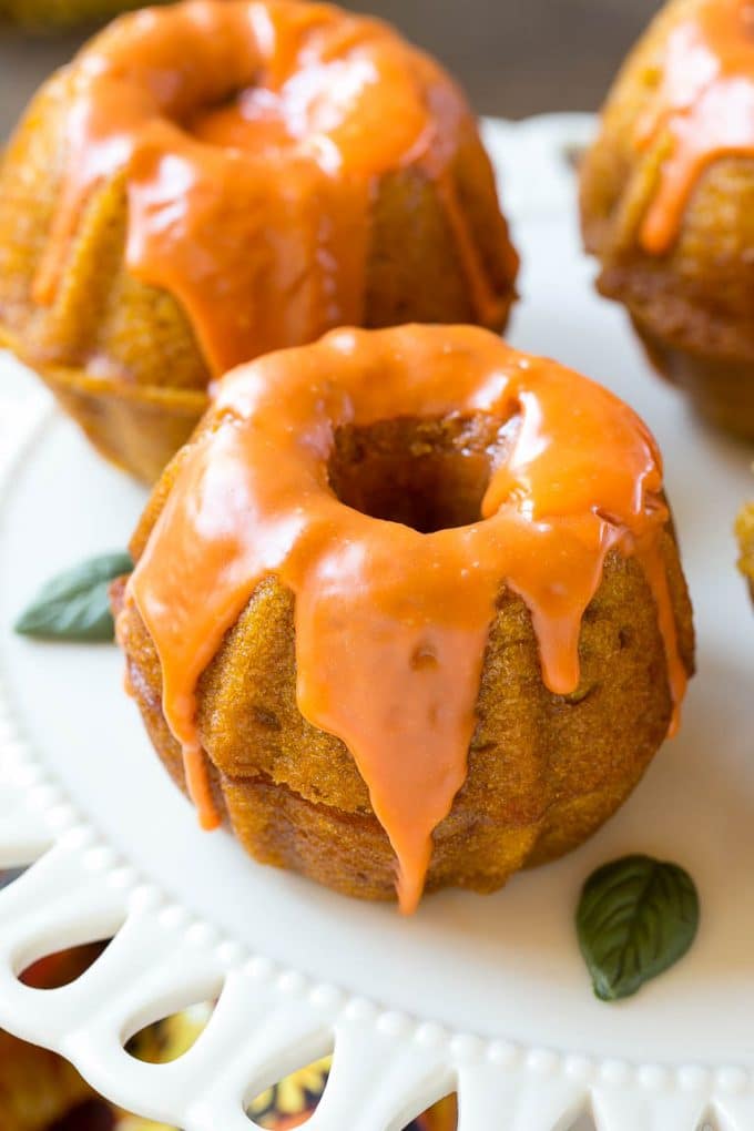 Pumpkin Spice Cake Recipe | Pumpkin Cake | Easy Pumpkin Cake | Thanksgiving Dessert #thanksgiving #pumpkin #cake #pumpkincake #spicecake #dessert #bajap #holiday Two bundt cakes stacked together with orange colored ganache on top.