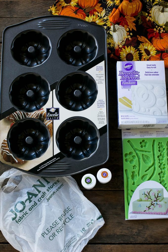 Pumpkin Spice Cake Recipe | Pumpkin Cake | Easy Pumpkin Cake | Thanksgiving Dessert #thanksgiving #pumpkin #cake #pumpkincake #spicecake #dessert #bajap #holiday Cake making tools including fondant, a cake pan, tubs of gel food color and fondant molds.