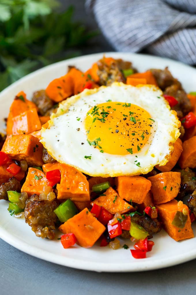 Sweet Potato Hash #sweetpotato #sausage #breakfast #brunch #bajap Sweet potato hash with sausage, topped with a fried egg.
