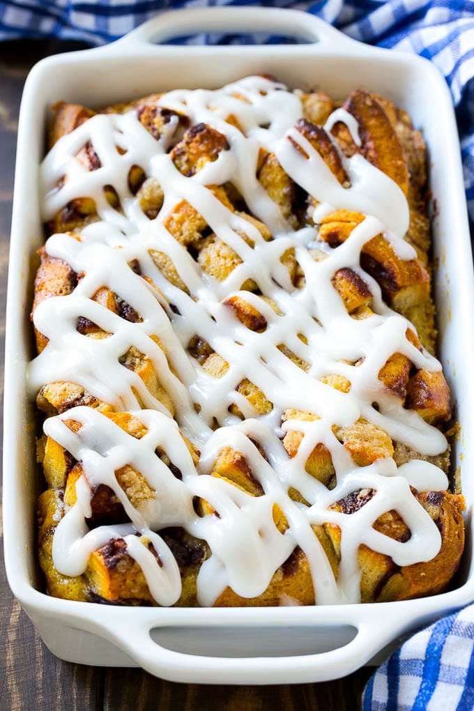 Cinnamon Roll French Toast Casserole | Cinnamon Roll French Toast Bake | Cinnamon Roll French Toast | Cinnamon French Toast #casserole #frenchtoast #cinnamonrolls #breakfast #bajap A casserole dish of cinnamon roll french toast with icing poured over the top.