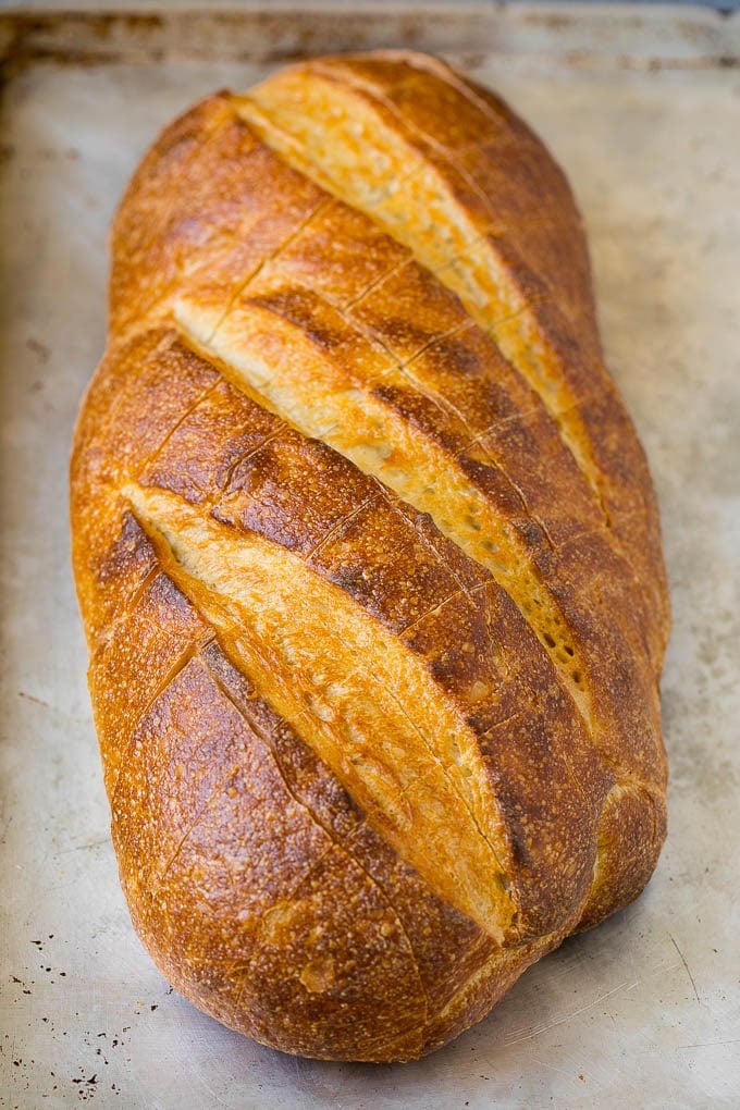 Pull Apart Bread | Garlic Bread | Cheese Bread #bread #garlic #cheese #sidedish #appetizer #bajap A loaf of bread on a sheet pan with diagonal cuts in it.