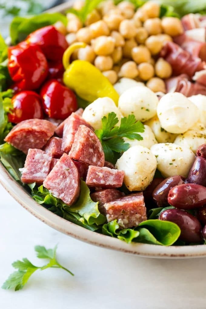 Antipasto Salad Recipe | Italian Salad | Main Course Salad | Antipasto Recipe #salad #salami #italianfood #dinner #lunch #bajap A bed of greens topped with antipasto salad including meats, cheeses, beans and vegetables.