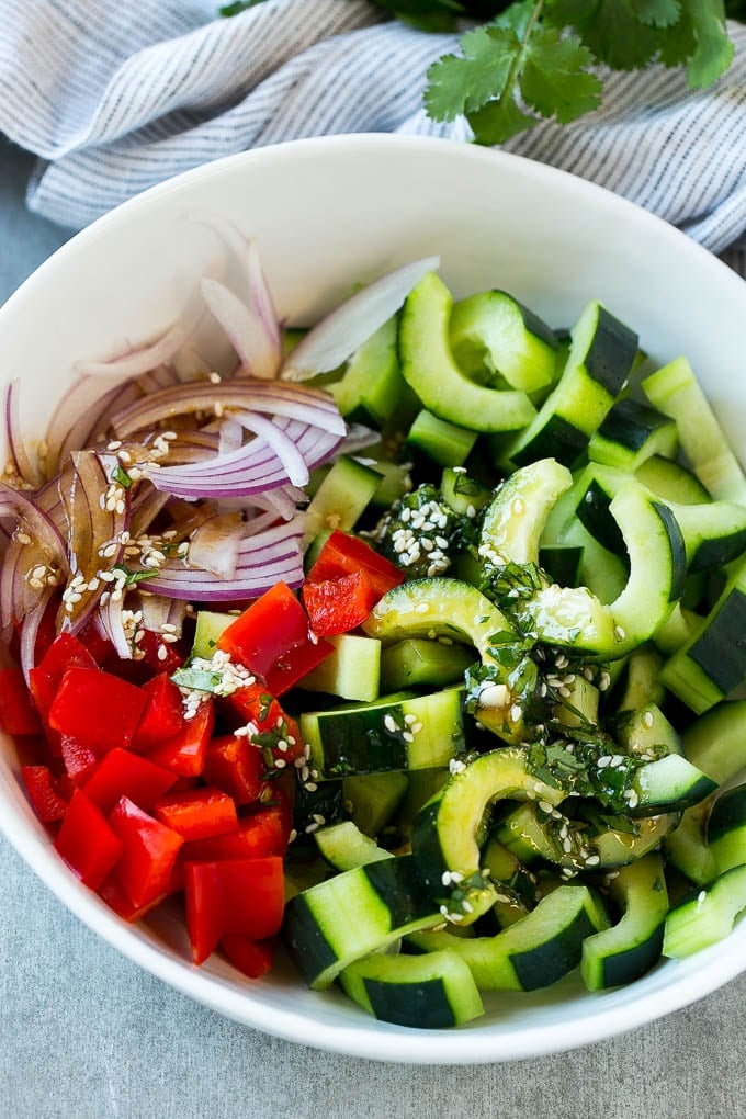 Sliced cucumbers, red peppers and onions with dressing.