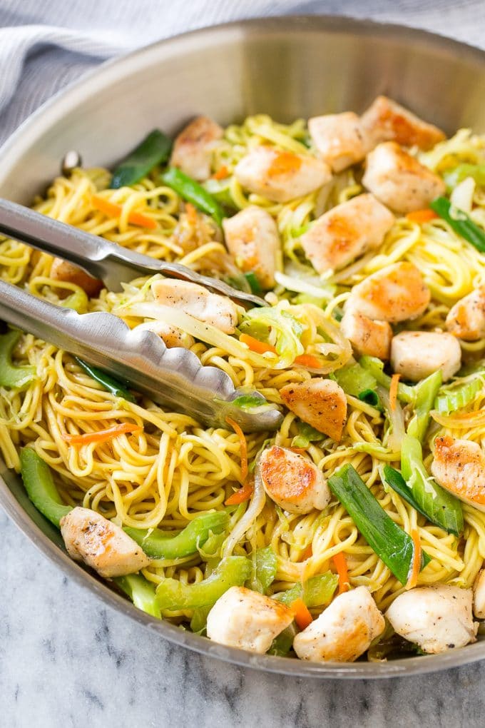 Chicken Chow Mein Recipe | Easy Chicken Recipe | Chow Mein | Chinese Food #chowmein #takeout #asianfood #bajap A pan of chicken chow mein with serving tongs in it.