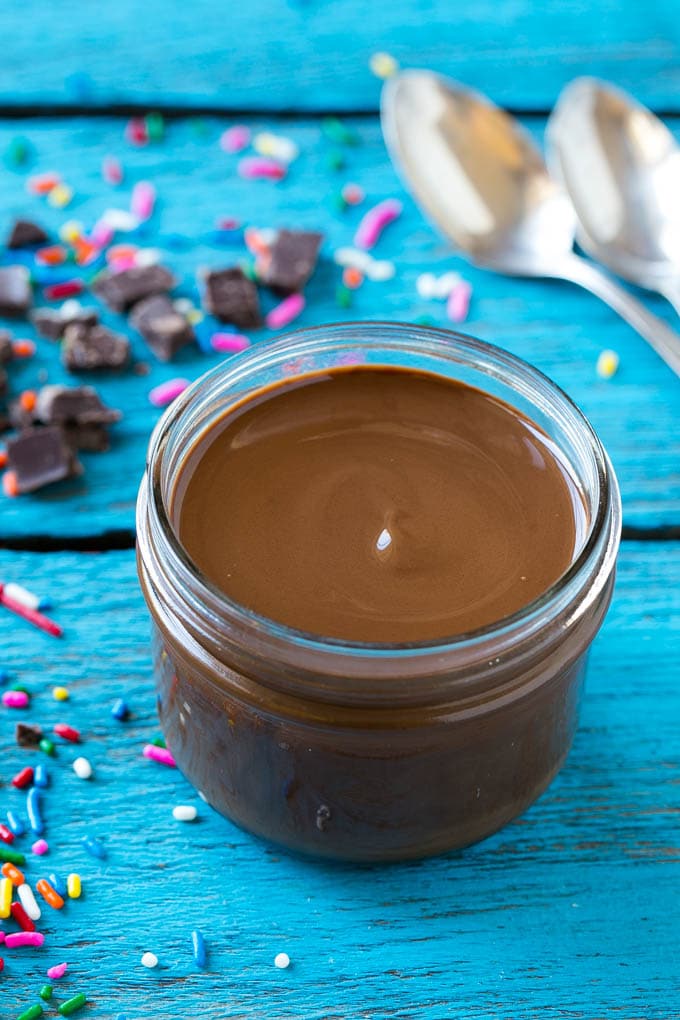 Homemade Magic Shell Recipe | Chocolate Ice Cream Topping | Chocolate Sauce | Hard Chocolate Coating #chocolate #icecream #dessert #bajap A jar of chocolate chocolate shell.