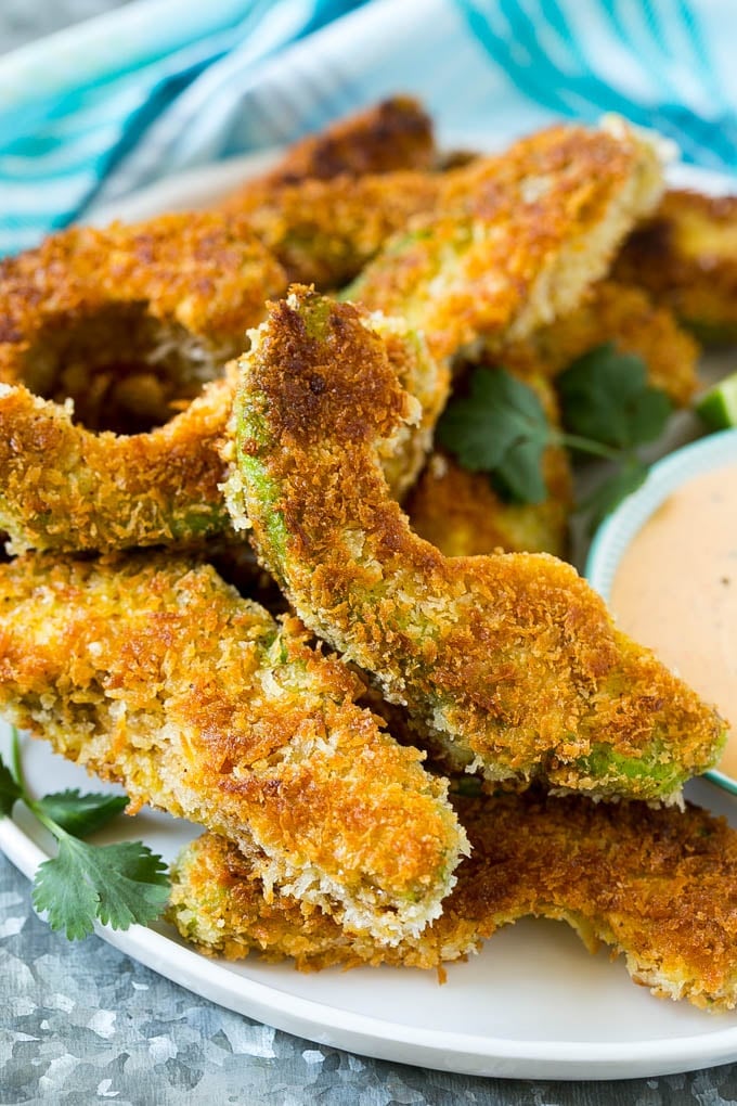 Avocado Fries Recipe | Fried Avocado | Avocado Fritters #avocado #appetizer #snack #bajap A plate of avocado fries garnished with fresh cilantro.
