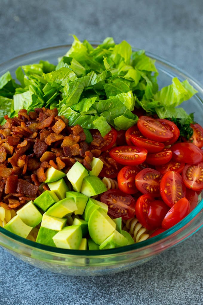 BLT Pasta Salad Recipe | Easy Pasta Salad | Bacon Pasta Salad #salad #pasta #blt #bacon #avocado #dinner #bajap Bacon, lettuce, tomato, pasta and avocado in a bowl.