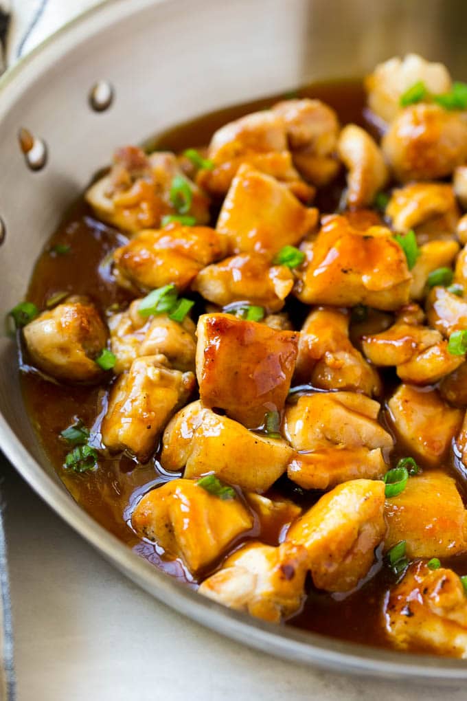 Bourbon Chicken | Sauteed Chicken | Chicken Stir Fry | Easy Chicken Recipe #chicken #dinner #bajap Bourbon chicken in a skillet coated in sauce and topped with green onions.