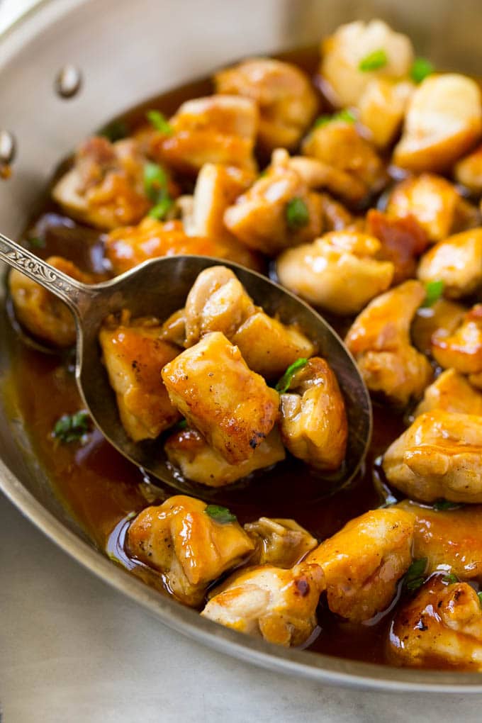 Bourbon Chicken | Sauteed Chicken | Chicken Stir Fry | Easy Chicken Recipe #chicken #dinner #bajap A pan of bourbon chicken with a serving spoon in it.