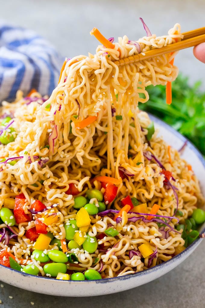 Asian Noodle Salad Recipe | Ramen Noodle Salad | Asian Salad #salad #noodles #edamame #vegetarian #bajap #lunch Chopsticks picking up noodles in a vegetable salad.