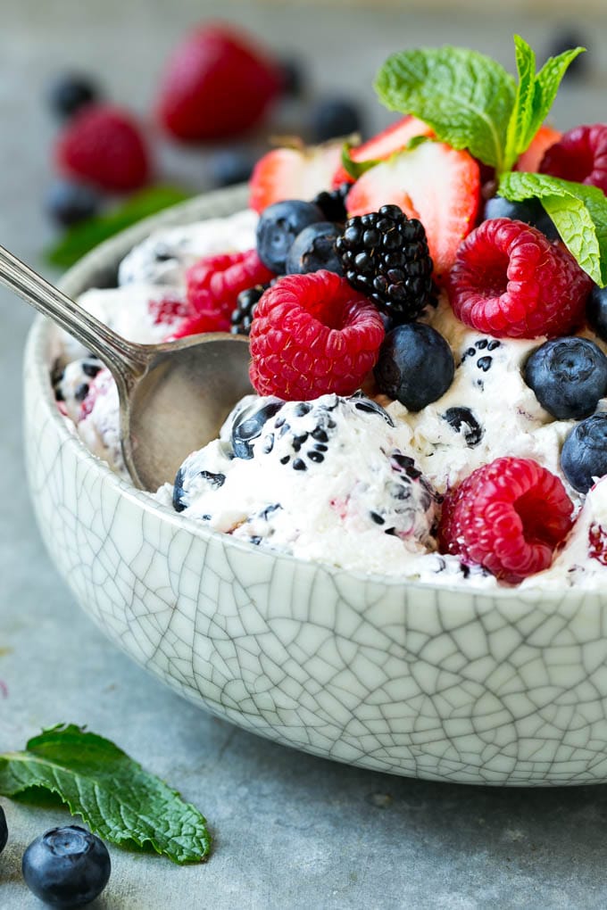 Berry Cheesecake Salad Recipe | Fruit Salad | Berry Fruit Salad | Cheesecake Salad #salad #cheesecake #fruit #berries #sidedish #dessert #bajap Berry cheesecake salad in a bowl garnished with fresh berries and mint.