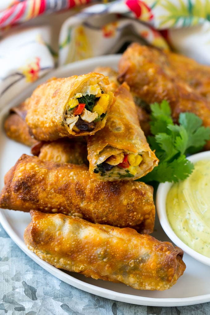 Southwestern Egg Rolls Recipe | Easy Egg Roll Recipe | Mexican Appetizer | Egg Roll Recipe | Southwest Egg Rolls #eggrolls #appetizer #chicken #snack #bajap Morsels stuffed with diced chicken, bell peppers, black beans and cheese on a serving plate.