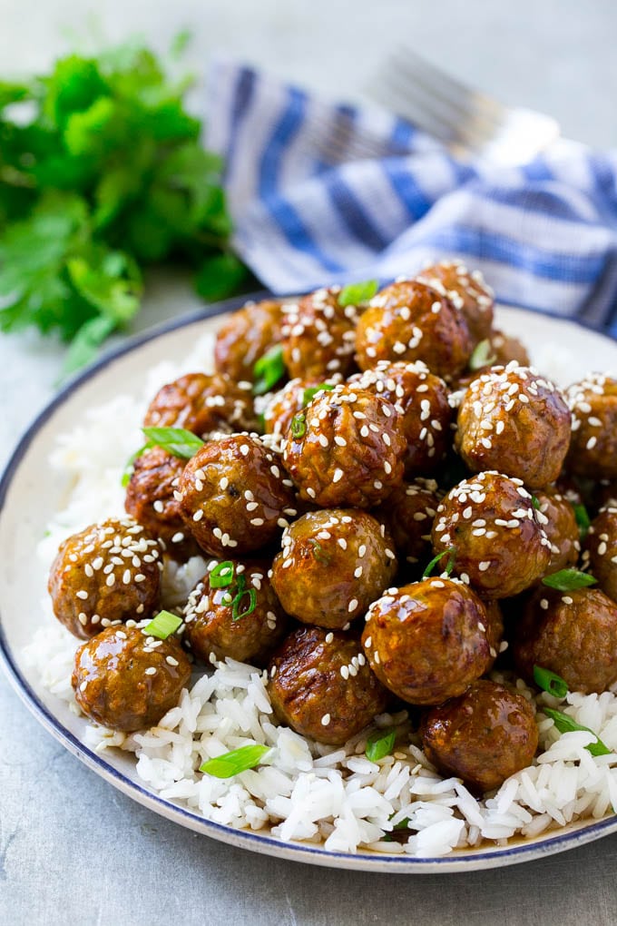 Teriyaki Meatballs Recipe | Asian Meatballs Recipe | Easy Meatball Recipe | Appetizer Meatballs #meatballs #teriyaki #beef #rice #dinner #bajap Teriyaki meatballs served over a bed of steamed rice and garnished with sesame seeds.