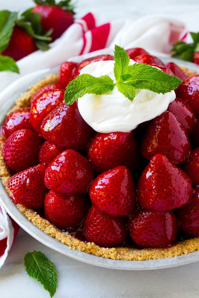 No Bake Strawberry Pie Recipe | Fresh Strawberry Pie | Strawberry Pie Recipe | No Bake Pie Recipe #strawberry #strawberrypie #nobake #nobakepie #dessert #bajap Strawberry pie with a pile of strawberries inside a graham cracker crust, topped with glaze and whipped cream.